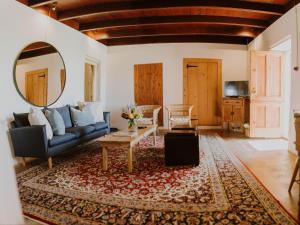 a living room with a couch and a mirror at Vleidam Guest Farm in Koringberg +84 photos