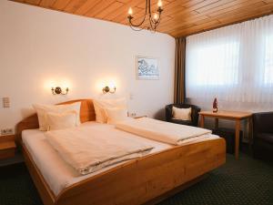 a bedroom with a large bed with a desk and a chair at Ferienweingut-Liebfried in Nehren +54 photos
