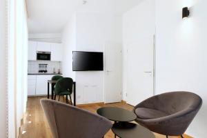a living room with two chairs and a table at Boardinghouse Rosenheim in Rosenheim