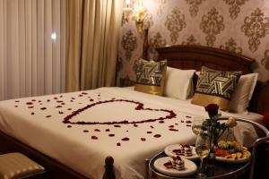 a bed with a heart made out of roses at Panorama Lisi Grand Hotel in Tbilisi City +47 photos