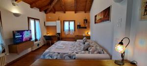 a bedroom with a large bed and a television at open space apt - comodo a Venezia in Treviso