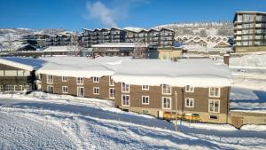 a building covered in snow in a city at Bergo Rom in Beitostøl