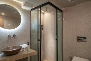 a bathroom with a sink and a glass shower at Infinity City Boutique Hotel in Heraklio +37 photos
