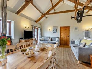a kitchen and living room with a wooden table at 4 Bed in Bude oc-corys in Morwenstow