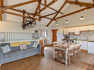 a living room with a couch and a table at 4 Bed in Bude oc-corys in Morwenstow