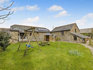 an old swing set in the yard of a stone cottage at 4 Bed in Bude oc-corys in Morwenstow