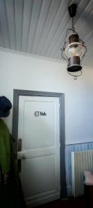 a white door with a nubs sign on a wall at chambre O'nids in Cahors