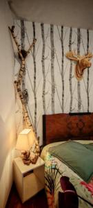 a bedroom with a bed and a wall with trees at chambre O'nids in Cahors