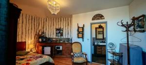 a bedroom with a bed and a chair and a window at chambre O'nids in Cahors
