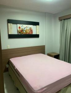 a bedroom with a bed in a room at Flat veredas 300 metros HOT PARK com ar na sala in Rio Quente +10 photos
