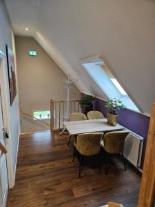 a dining room with a table and some chairs at Veenemaat B&B in Winterswijk