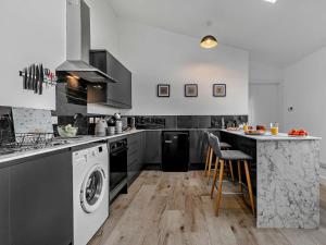 a kitchen with a washer and dryer at 1 Bed in Penzance oc-93410 in Sennen +8 photos