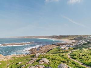 a view of a beach with rocks and the ocean at 1 Bed in Penzance oc-93410 in Sennen