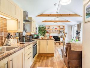 a kitchen with wooden cabinets and a sink at 1 Bed in Bodmin oc-88049 in Luxulyan