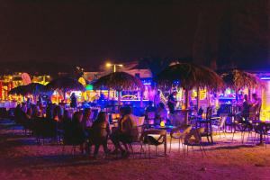 a group of people sitting in chairs on the beach at night at Apartmant with Pool 8 in Kaštela +71 photos