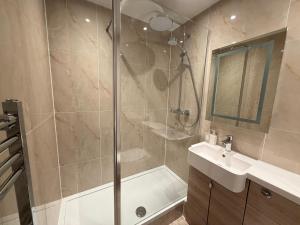 a bathroom with a shower and a sink at Sonas Guesthouse in Edinburgh