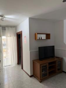 a living room with a flat screen tv on a cabinet at Mont-Roig Del Camp in Tarragona