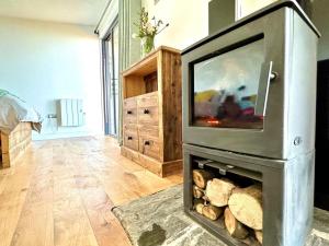 a fireplace with a television on top of it at 1 Bed in Bude oc-88499 in Morwenstow