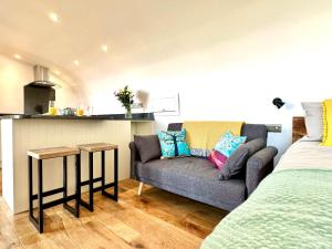 a living room with a couch and a kitchen at 1 Bed in Bude oc-88499 in Morwenstow +10 photos