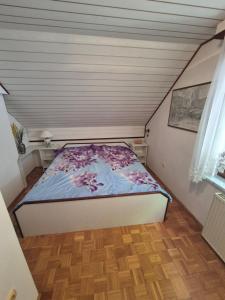 a small bedroom with a bed in a attic at Počitniška hiša Novak in Bohinj