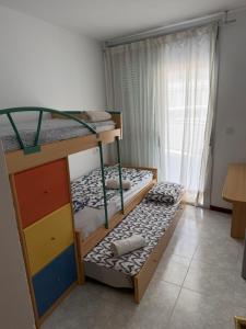 two bunk beds in a room with a window at Mont-Roig Del Camp in Tarragona +49 photos