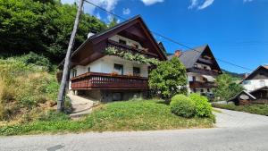 a house with a balcony with flowers on it at Počitniška hiša Novak in Bohinj