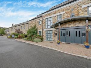 a brick building with a garage on a street at 3 Bed in Lostwithiel oc-93041 in Lostwithiel +13 photos