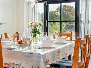 a dining room table with a table cloth with flowers on it at 3 Bed in Lostwithiel oc-93041 in Lostwithiel
