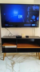 a flat screen tv sitting on top of a tv stand at Terramar condominium! Coral beach! in Tamoios