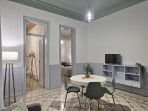 a living room with a table and chairs at La Mattanza in Trapani