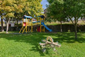 a park with a playground with a slide at Casa lo Sastre - Jasa in Jasa