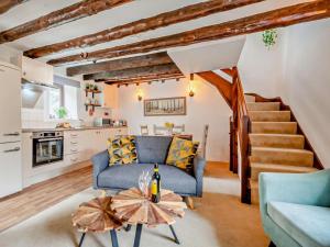 a living room with a blue couch and a table at 2 Bed in Bodmin oc-90216 in Bodmin