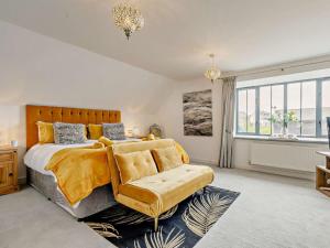 a bedroom with a bed and a chair and a window at 3 Bed in St. Austell oc-90218 in Charlestown