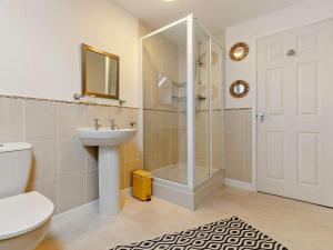 a bathroom with a shower and a sink and a toilet at 3 Bed in St. Austell oc-90218 in Charlestown +17 photos