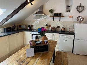 a kitchen with a table with a welcome sign on it at 4 Bed in Bodmin oc-90215 in Bodmin