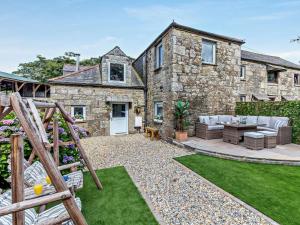 a stone house with a garden in front of it at 4 Bed in Bodmin oc-90215 in Bodmin