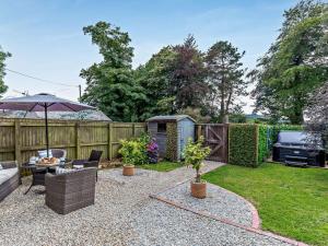 a backyard with a couch and an umbrella at 3 Bed in Bodmin oc-90217 in Bodmin