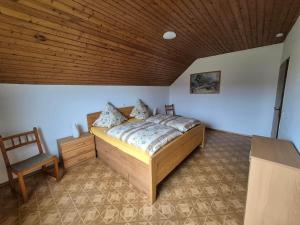 a bedroom with a bed and a wooden ceiling at Ferienwohnung Marx in Konz