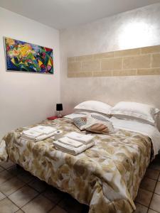 a bedroom with a large bed with towels on it at White Suite B&B in Lecce