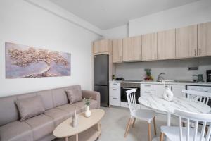 a living room with a couch and a table at Notos Horizon in Ierapetra