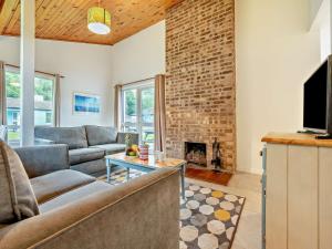 a living room with a couch and a fireplace at 3 Bed in Saltash oc-30040 in Wotter