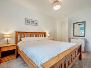 a bedroom with a large bed with a wooden frame at 3 Bed in Saltash oc-30040 in Wotter +19 photos