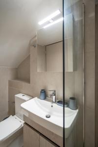 a bathroom with a sink and a mirror at Notos Horizon in Ierapetra +41 photos