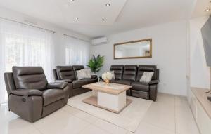 a living room with two chairs and a table at Villa Korana with heated Pool & Jacuzzi in Kamenmost