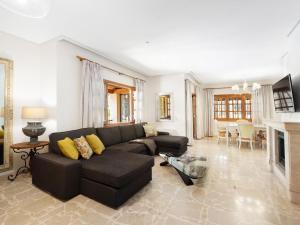 a living room with a black couch and a fireplace at Sa casa des Padrino in Santa Ponsa
