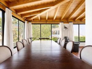 a long table and chairs in a room with windows at Sa casa des Padrino in Santa Ponsa +35 photos