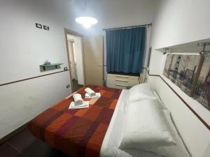 a bedroom with a bed with two shoes on it at Casa Frisella in Marsala