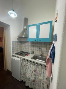 a kitchen with a sink and a stove at Casa Frisella in Marsala +6 photos