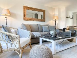 a living room with a couch and a table at Strandbude in Timmendorfer Strand