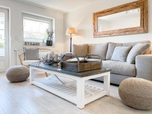 a living room with a couch and a table at Strandbude in Timmendorfer Strand